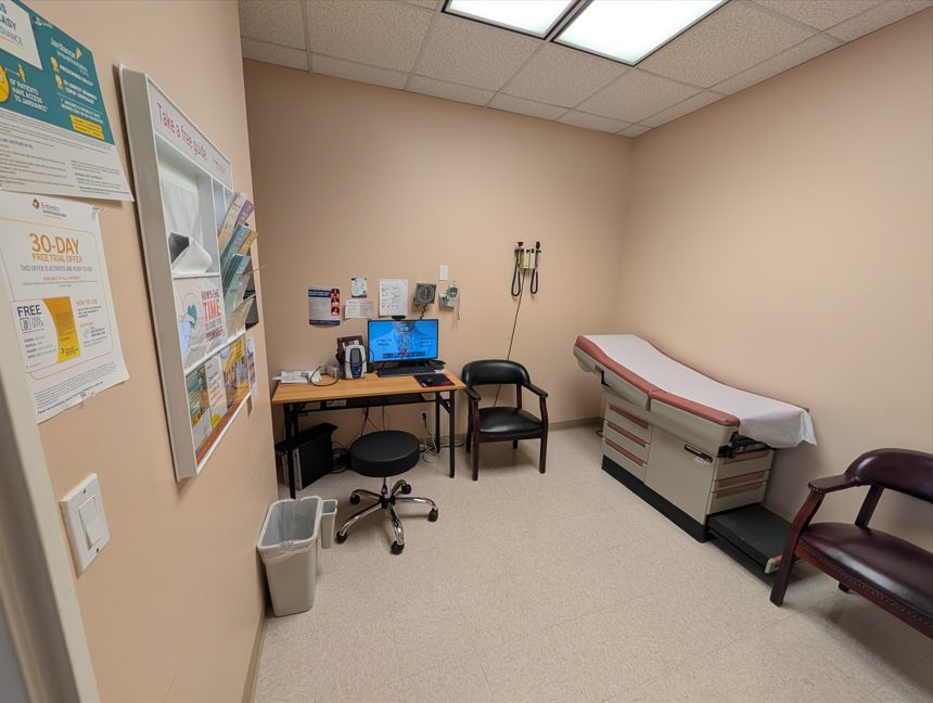 Examination room with exam table and medical equipment at Bissonnet Internal Medicine